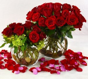Romantic red roses designed in a sleek and slender glass vase elevating the style of any space. Rock your Valentine with 12 roses or rock them more with 24 roses! 