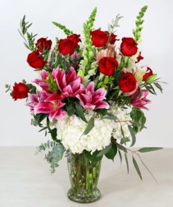 A delightful arrangement for your starry eyed rose dreamer. Our Starry Eyed Roses features our premium red roses intertwined with fragrant stargazer lilies. Elevate the presentation to grand with the inclusion of hydrangea, snapdragons and seasonal foliage. 