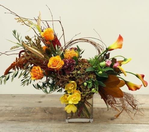 Fall in love with the vibrant colors and textures of Autumn. Our Autumn Soiree blossoms with roses, chrysanthemums, gerbera daisies, hydrangea with seasonal flowers and foliages, designed in a glass vase.
