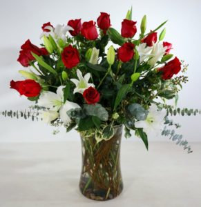 Our premium twelve red roses are intertwined with fragrant white oriental lilies and hydrangeas